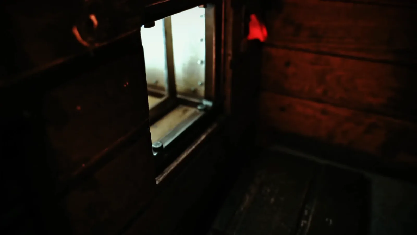 A hatch opening in the side of a Buried Alive coffin